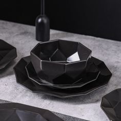 black plates and bowls are on the table