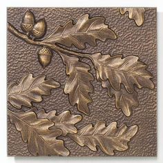 an oak leaf and acorn design on a leather background