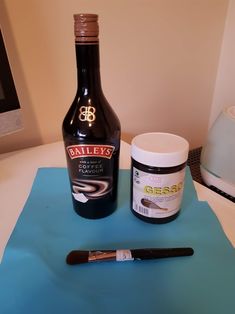 a bottle of bailey's and a brush on a table