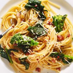 a white plate topped with pasta and broccoli