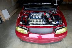 the engine compartment of a red sports car