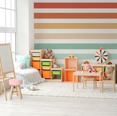 a child's room with colorful striped walls and furniture