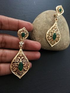 "These are lovely dangling chandelier style earrings in gold .an vintage style gold  teardrop dangle earrings  These are an Indian earrings that could be worn by both traditional and an western attire. This Unique jewellery is designed and crafted at Abi CreatioNzs Abi CreatioNzs is the place for anyone who Is in lookout for a latest trend with an ethnic touch.  We at Abi CreatioNzs offers a great range of Indian Ethnic jewellery's. We are strongly committed to  providing our customers  some uniquely handcrafted products with utmost satisfaction.  Note: The product shipped will be same as shown in the picture however, actual colours may vary slightly from those shown due to lighting in the photography Pls note The shades of gold / silver  may vary slightly. We do not accept any returns or Gold Teardrop Chandelier Earrings For Festive Occasions, Festive Teardrop Chandelier Earrings With Latkans, Teardrop Bridal Earrings With Intricate Design, Festive Teardrop Danglers With Pierced Detail, Festive Bridal Teardrop Earrings With Intricate Design, Festive Teardrop Bridal Earrings With Intricate Design, Vintage Wedding Danglers With Intricate Design, Ornate Drop Earrings With Latkans, Gold Teardrop Bridal Earrings With Intricate Design