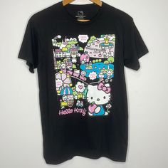 New Without Tags, Still Has The Plastic Thing From The Tag Hello Kitty By Sanrio Size Small, Medium, And Large Available Short Sleeve Crewneck Shirt Black With Front City Graphic 100% Cotton I Have This Available In White Long Sleeve As Well! Multicolor Hello Kitty Print Short Sleeve Tops, Multicolor Hello Kitty Crew Neck Top, Black Hello Kitty Print Short Sleeve Top, Black Kawaii T-shirt With Hello Kitty Print, Multicolor Hello Kitty Print Crew Neck Top, Multicolor Short Sleeve T-shirt With Hello Kitty Print, Black Hello Kitty Print Top For Spring, Casual Black Hello Kitty Top, Casual Black Hello Kitty Print Top