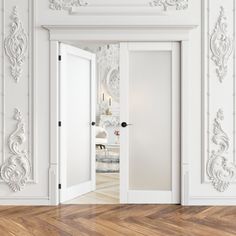 an empty room with white walls and wood flooring is pictured in this image, there are two doors that lead into the hallway