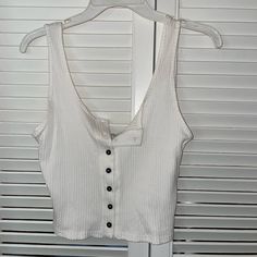 This Is A White Cropped Tank Top With Buttons Up The Front. It Is A Size Small But Fits More Like A Medium Or Large. It Is Still New With Tags Bought It And It Didnt Fit . Ask Any Questions And Make Me An Offer! White Button Up Tank Top, Button-up Crop Top With Buttons For Day Out, White Cotton Tank Top With Buttons, Casual White Buttoned Tank Top, White Cotton Buttoned Tank Top, White Cotton Tank Top With Button Closure, Casual Crop Top With Button Closure For Day Out, White Casual Crop Top With Buttons, Casual White Crop Top With Button Closure