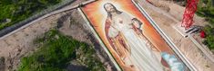 an aerial view of a large painting of jesus on the side of a building