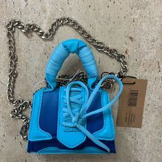 This Steve Madden Bdoraa Top Handle Bag Is A Stylish Accessory For Women. The Bag Features A Beautiful Turquoise Exterior Made Of A Blend Of Polyester, Nylon, And Polyurethane Materials. It Has A Small Size With A Width Of 2 Inches, A Height Of 4 Inches, And A Length Of 5 Inches. The Handle Drop Is 3 Inches And The Chain Drop Is 24”. The Bag Comes With A Detachable Strap And A Pouch For Added Convenience. The Handle/Strap Color Is Chain, And The Lining Color Is Blue. The Bag Is Perfect For Any Occasion And Is A Great Addition To Any Wardrobe. Leather Tote Purse, Black Leather Crossbody Bag, Black Leather Tote, Small Crossbody Bag, Coin Pouch, Black Handbags, Stylish Accessories, Purses Crossbody, Cross Body Handbags