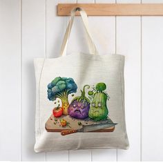 a tote bag with vegetables on it hanging from a hook