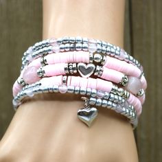 Show your love with this stunning Rose Quartz heart stack love bracelet. Featuring genuine rose quartz stones linked together in a unique heart stack design, this bracelet is a beautiful symbol of your everlasting love. #rosequartz #silver #memorywire #claybeads #statementjewelry #crystals #beads #bracelet #coilbracelet #romance #polimerclay #wrapbracelet #Valentine #oneofakindjewelry #love #gift #fashion #bemine #pearls #style #wedding #sparkle #jewels #beautiful #beauty # Silver Spiritual Bracelet With Heart Beads, Bohemian Silver Heart-shaped Beaded Bracelets, Bohemian Silver Beaded Heart Bracelets, Rose Quartz Properties, Rose Quartz Bracelet Beads, Beaded Memory Wire Bracelets, Red Beaded Bracelet, Beaded Memory Wire, Stone Accessories