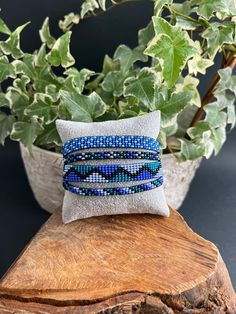 This beaded bracelet is one bracelet with four strands connected in the back.  This one-of-a-kind beaded bracelet is the perfect eye-catching piece needed to complete your look and are 100% handmade and a unique design. Colors: Blue & Black Length: Adjustable  Width: 1.5 Inches  Check out other similar products in our store and visit us at: https://www.etsy.com/shop/Eklectyc Beaded Multi-strand Bracelets As Gifts, Multi-strand Beaded Wrap Bracelet Gift, Adjustable Multi-strand Beaded Bracelets For Gifts, Beaded Multi-strand Stretch Bracelet Gift, Multi-strand Beaded Stretch Bracelet As Gift, Bracelets Hippie, Hippie Bracelet, Boho Chic Bracelets, Blue Beaded Bracelets