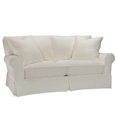 a white couch with two pillows on it's back and the arms folded down