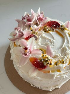 a cake with white frosting and flowers on top