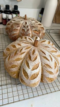 three loaves of bread sitting on top of a counter next to other food items