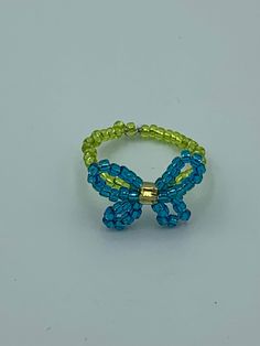 A beaded butterfly ring. Can be worn alone or stacked. Looks cute on any finger. Handmade Cute Green Ring, Adjustable Beaded Rings For Summer, Handmade Cute Green Rings, Cute Green Handmade Rings, Blue Beaded Rings For Gifts, Blue Beaded Rings As Gifts, Blue Beaded Rings As Gift, Blue Beaded Rings As A Gift, Green Beaded Rings For Gifts