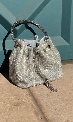 This Crystal Bag is an elegant accessory featuring a full-covered rhinestone design, a detachable chain strap, and a small pouch with a hard crystal metal handle. Perfect for adding a touch of sparkle and sophistication to any ensemble, this bag is a must-have for any fashion-forward wardrobe. Crystal Bags, Small Pouch, Small Pouches, Rhinestone Designs, Elegant Accessories, Chain Strap, Sale Items, Must Haves, Fashion Forward