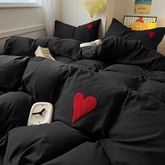 a black comforter with a red heart on it