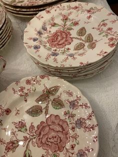 a table topped with lots of plates covered in flowers