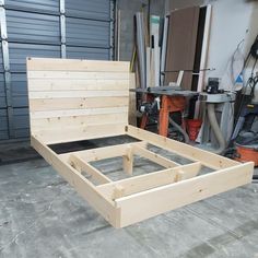 a bed frame made out of wood in a garage