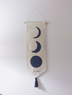 a banner hanging on the wall with two crescents and a tasseled cord