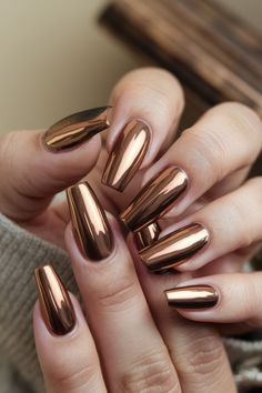 Metallic bronze nails bring a high-shine, luxurious finish to long nails, perfect for a standout yet minimalist fall design. #MetallicBronzeNails Bronze Metallic Nails, Copper Chrome Nails Fall, Chrome Nails Designs Fall, Bronze Chrome Nails, Metallic Nail Colors, Elegant Nail Polish, Brown Chrome, Bronze Nails, Pedi Ideas