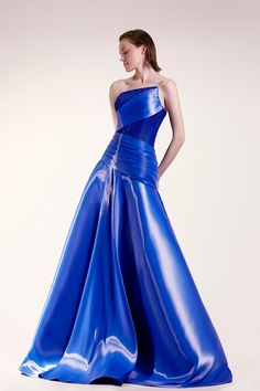 Description Blue A-line, Long dress Sleeveless Open neckline Strapless Organza Dry Clean Made in Lebanon SKU GCS 1415 Luxury Designer Blue Dresses, Luxury Organza Dress With Ruched Bodice, Luxury Asymmetrical Dress With Ruched Bodice, Luxury Blue Elegant Strapless Dress, Luxury Organza Gown With Ruched Bodice, Luxury Blue Dresses With Flattering Silhouette, Luxury Organza Dress With Asymmetrical Neckline, Luxury Hand Embellished Blue Gown, Luxury Blue Satin Finish Gown