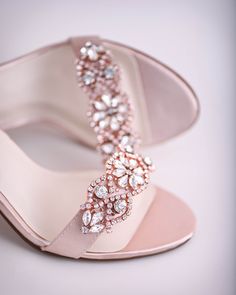 a pair of pink high heeled shoes with pearls