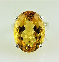 ALL OUR GEMSTONES ARE NATURAL NOT LAB CREATED ALL OUR JEWELRY IS HANDCRAFTED IN THE U.S.A. This fine quality richly colored Bolivian Citrine with a wonderful golden -yellow hue set in a bold, traditional design. This is a comfortable solitaire ring can be made of solid 925 sterling silver or gold, 10kt or 14kt. This is a great everyday ring that you'll wear everywhere, from the grocery to date night. makes a perfect gift. Citrine is the Birthstone for November. Citrine 20X15 MM oval - 18.55 Cara Classic Oval Faceted Topaz Ring, Classic Oval Citrine Rings, Yellow Oval Faceted Jewelry, Formal Oval Yellow Topaz Ring, Formal Yellow Oval Topaz Ring, Classic Oval Citrine Gemstones, Oval Yellow Citrine Gemstones, Fine Jewelry Yellow Oval Topaz Ring, Oval Faceted Topaz Anniversary Ring