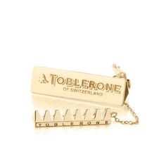 The 14k solid gold Swiss Chocolate Charm pays tribute to the iconic, prism-shaped milk chocolate Toblerone that can be found duty-free across the world. Our version of the honey and almond speckled treat can be taken out of its enclosure, which is secured via a small chain. Purchased as a gift or for mid-flight nougat nibbles, you can purchase extra-large 12 peak chocolate bars duty-free but your Swiss Chocolate Charm is the perfect miniature replica with eight peaks. Approximate dimensions: 1 1 Chocolate Toblerone, Gold Chocolate, Swiss Chocolate, Solid Gold Charms, Chocolate Bars, Gold Bar, Jewelry Inspo, Dream Jewelry, Milk Chocolate