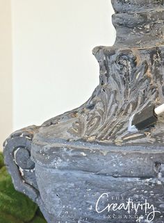 an old gray vase sitting on top of a table