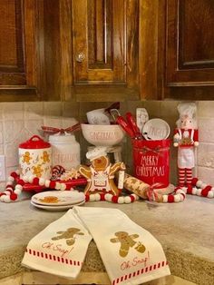 the kitchen counter is covered in christmas themed dishes and decorations, including gingerbread cookies