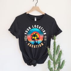 a black t - shirt that says your location is vacation with a palm tree on it