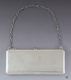 "Presented is a fantastic quality vintage Estonian silver clutch style handbag,    dating to circa 1924-1939. The clutch is rectangular with a very sleek and    smooth design. The \"strap\" is a silver chain, with twist design links. The    interior is lined in rich green velvet. The case opens with a little thumbpiece    set with a red stone. The overall look is incredibly stylish.      This piece is in excellent overall condition. There is some minor wear to the    lining, please view the phot Silver Clutch Purse, Silver Clutch, Silver Bags, Stylish Art, Rich Green, Pocket Book, Red Stone, Bags Purses, Green Velvet