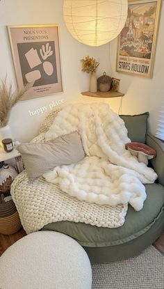 a living room filled with lots of furniture and pillows on top of a round couch