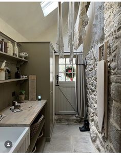 a bathroom with stone walls and open shelving