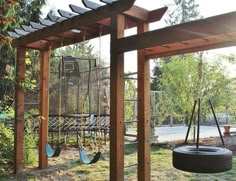 a swing set and tire in a park