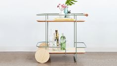 a metal and wood trolley with drinks on it