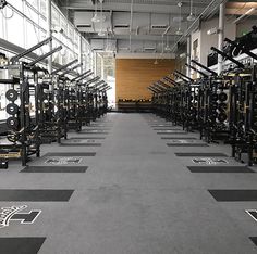 an empty gym with rows of exercise equipment