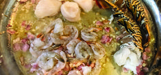 shrimp and other seafood are being cooked in a pan