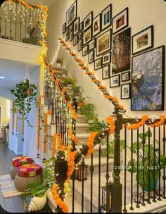 the stairs are decorated with orange garlands and flowers on them, along with pictures