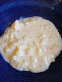 a blue bowl filled with food on top of a table