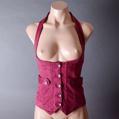 Material (Faux Suede): 92% Polyester 8% Spandex Elasticized Halter Neck Button-Front Closure Button-Tab Accents Corset Lace-Up Ties At Back Length Measured From Shoulder To Back Hem Measurement: Size S: Length (Shoulder To Back Hem): 19" Bust: Up To 35 Bust Size M: Length (Shoulder To Back Hem): 20" Bust: Up To 37 Bust Size L: Length (Shoulder To Back Hem): 21" Bust: Up To 39 Bust Fitted Red Vest Outerwear, Fitted Red Outerwear For Festival, Fitted Button-up Vest With Buttons, Fitted Cotton Button-up Vest, Fitted Vest For Cosplay In Fall, Fitted Red Vest For Winter, Fitted Fall Vest With Snap Buttons, Fitted Red Winter Vest, Fitted Steampunk Vest For Fall