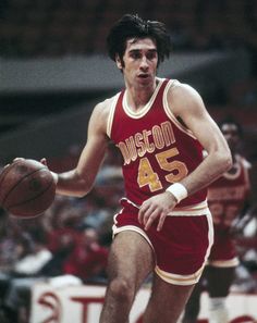 a basketball player dribbles the ball during a game