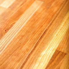 a close up view of a wood floor with some grains on the wooden surface