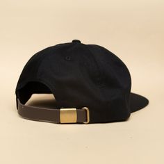 A premium cotton, unstructured, pinch front 5 panel, flat bill, with a premium leather strap with brass clasp. Designed and decorated in Oregon with 3D embroidery. Classic Adjustable Baseball Cap With Flat Crown, Classic Black Baseball Cap With Flat Crown, Black Leather Snapback Hat With Curved Brim, Adjustable Flat Crown Baseball Cap, Black Snapback Hat With Leather Patch, Black Leather Adjustable Snapback Hat, Adjustable Baseball Cap With Leather Patch And Flat Brim, Black Snapback Hat With Leather Patch And Curved Brim, Adjustable Flat Brim Hat With Waxed Finish