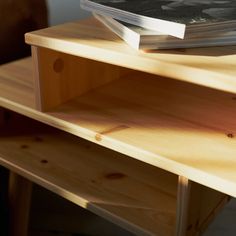 a book is sitting on top of a wooden shelf