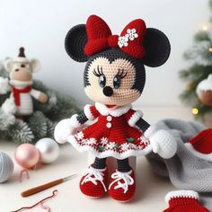 there is a crocheted minnie mouse doll next to some christmas trees and decorations