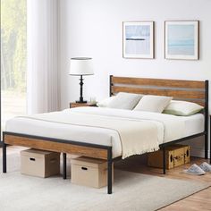 a bed sitting in a bedroom next to a dresser and lamp on top of a wooden floor