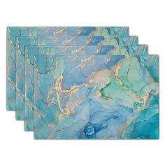 set of four placemats in blue and gold marbled paper, each with an abstract design