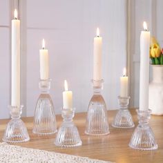 candles are lit on a wooden table